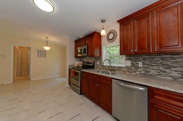 Cherry Cabinets and Desert Gold Granite by Global Home Decor.