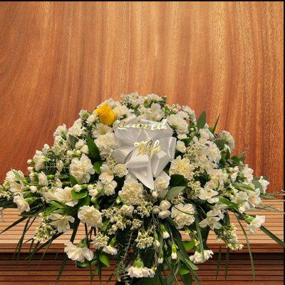 Casket Spray.  This piece is placed on top of the casket to add beauty to your loved one's farewell tribute.