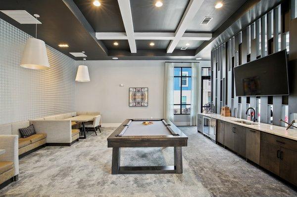 Game room with a billiard table, wet bar and booth-style seating areas at Lantower Garrison Park.