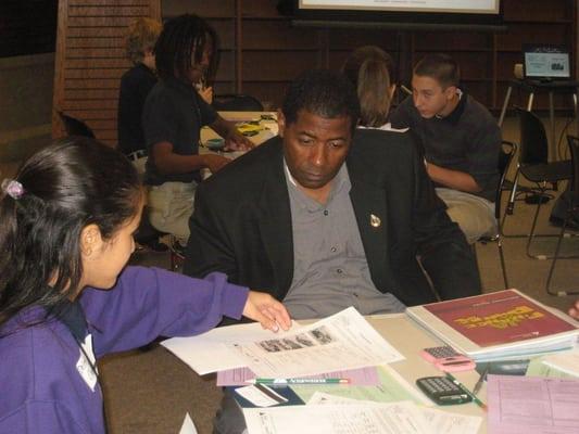 Julius Bedford, JA ExxonMobil Board Member mentors 8th graders on personal finance at JA Finance Park