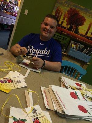 tying brochures to the bags used when customers buy products