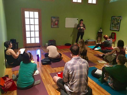 Meg Peron, RYT-200, leading a discussion on "Economy of Language" in Yoga Teacher Training.