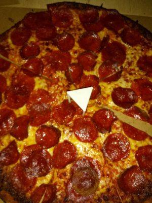 A large thin crust, extra pepperoni, pizza.