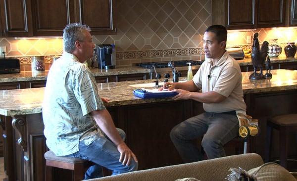 KY-KO Technician reviewing termite inspection with homeowner.