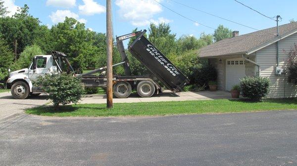 Setting a 10 yard dumpster in a driveway in New Albany, Indiana