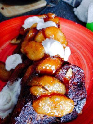 Banana Foster stuffed French toast with caramelized bananas and fresh whipped cream