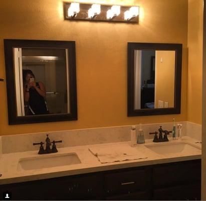 New lights, New sinks, New Countertop, Removed Side cabinet mirror & patched wall with added Texture, 2 coats of paint everywhere, Classy.