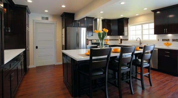 Chocolate finish wood custom cabinets,color quarz counter tops, porcelain backsplash w/glass ribbon, LED lights, wood like tile