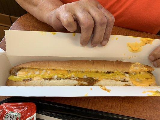 Footlong coney dog with onions mustard and cheese.