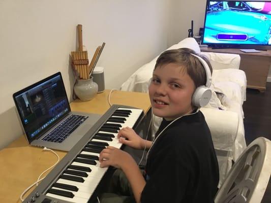 Student composing his own music, using Garageband, during weekly Music Lab.