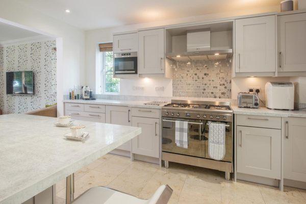 Beautiful Kitchen renovated with Portland white quartz countertops, white shaker cabinets, and Liberty Diamond backsplash