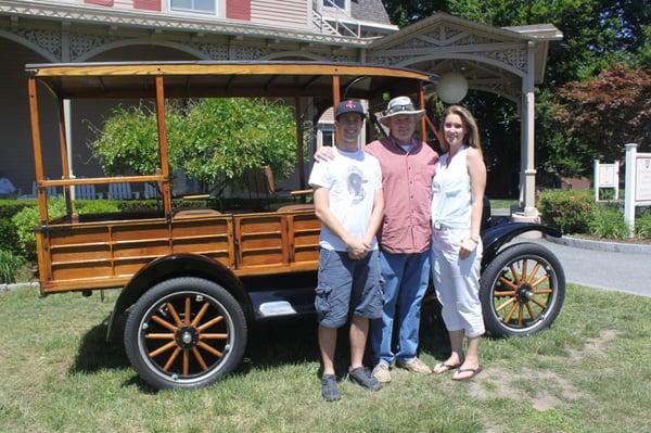 Hartley's Pork Pie owner Don and his two children Zachary and Kayla standing next to the family car, a 1919 Ford Model T.