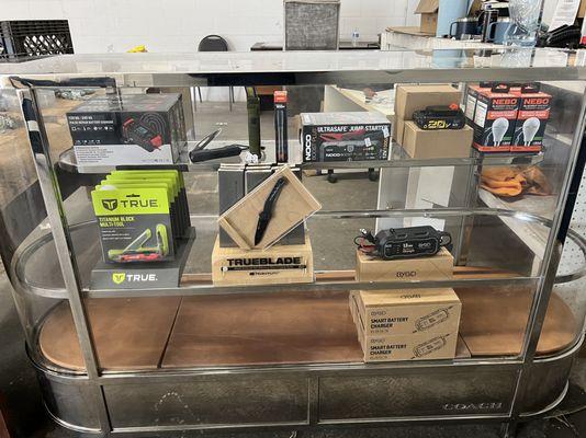 Auto parts display case: NEBO light, jump starter, pocket knife, etc