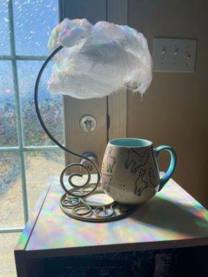 Cloud of cotton candy raining over a hot cup of coffee.