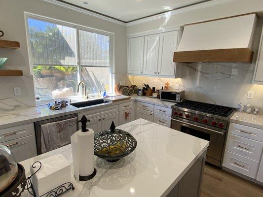 Custom Kitchen Cabinet: Gray Color Island with White Cabinets else where.White Oak Shelves, Carrara Look porcelain Counter top.