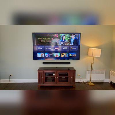 85" samsung tv, flat mounted on wall.
Under it is a Sonos Arc soundbar wireless linked to 2 Sonos One's for surround and one Sonos Sub.