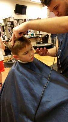 Zach loves getting his hair cut in the race car chair