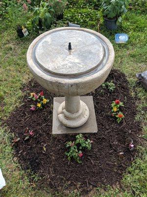 Bird bath assembled and flowers planted.