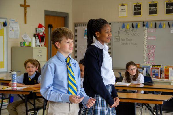 Fifth graders presenting their debate project