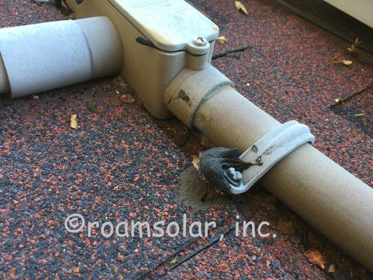 Pipe strap failure let water into the roof.  Conduit should never sit directly on the roof !