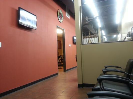 Salon chairs, waiting area and a mini bar nearby. Very clean!