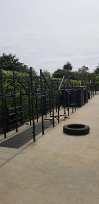 The outdoor functional area, fully equipped with barbells, olympic plates, kettlebells, sleds, ropes, and more.