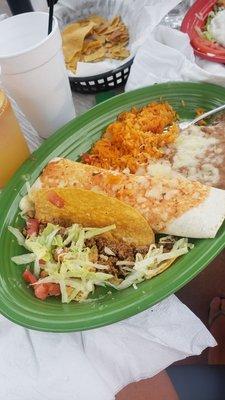 Beef taco and shredded chicken burrito with rice and beans.