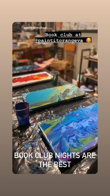 Acrylic pour paintings laying on a table.