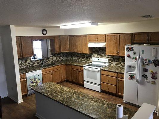 Kitchen Renovation, we installed counter tops and new cabinets were stained to customers preference & hung.