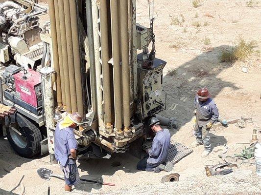 The 3 man drill team focused on the well.