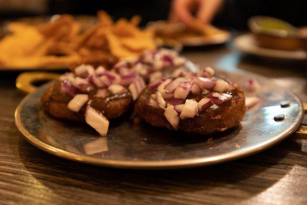 Potato pancakes topped with red onion