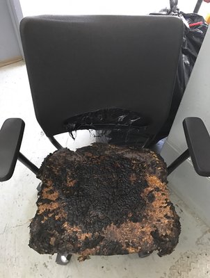 Chair that was in fire in building left in hallway