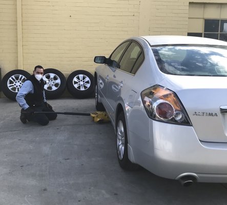 Lalo removing old tires from my 2012 Nissan Altima