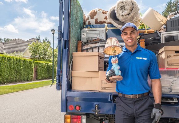 1-800-GOT-JUNK? Long Island East truck team member with a loaded junk truck