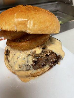 Smoky Mountain Burger topped with beer cheese,  beer battered onion ring, beef brisket and pulled pork.