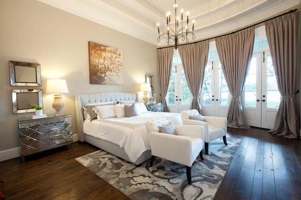 Rustic wood floors, high ceilings and light, neutral decor make this bedroom just dreamy!