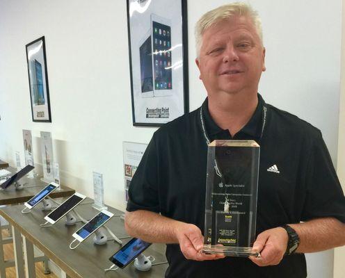 General Manager Jeff Thomas displays the award Apple presented, recognizing Connecting Point's decades as an Apple partner.