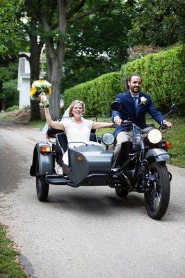 Bride and groom on a motorcycle with a sidecar.  Photo by kellyjophoto.com.