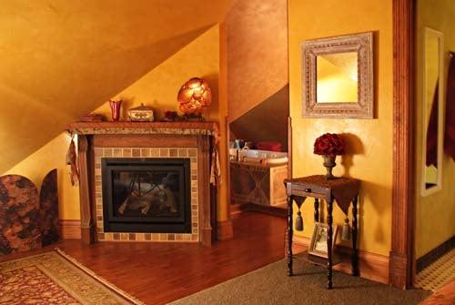 Attic Suite fireplace with whirlpool tub in the background.