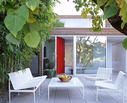 Garden entry court.  What is behind the red door? A bright and airy new home!