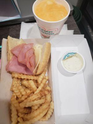 Kids meal with ham & Swiss sandwhich and mango tango eegees.