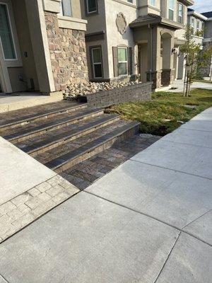 Pavers steps with lights and seating wall..