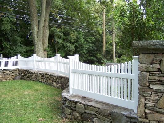 Victorian picket fence set on stone wall, in Westport, CT.