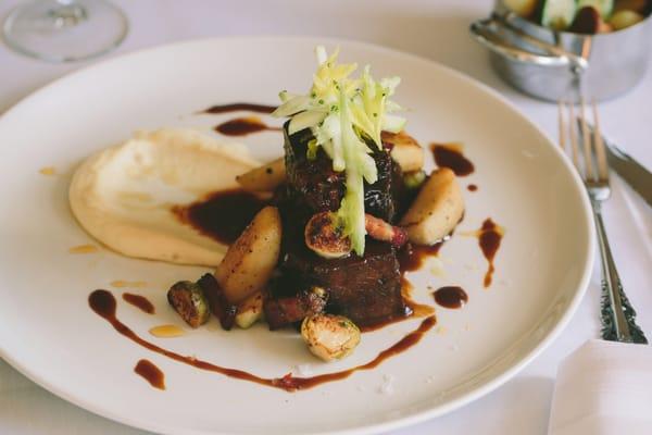 SLOW-BRAISED SHORT RIBS Parsnip puree, brussels sprouts, pork belly, and tart apples