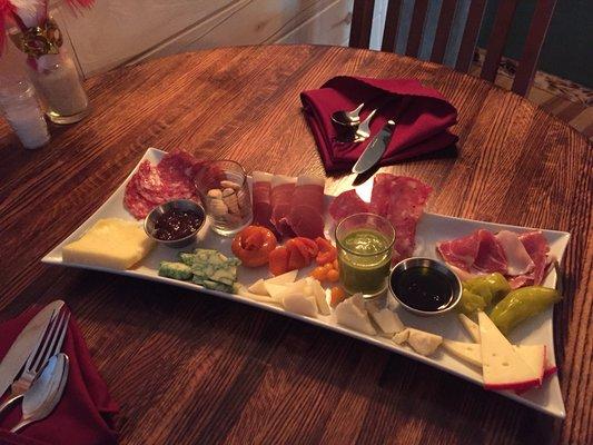 Charcuterie plate full of tasty cured meats , cheese from around the world and condiments to create a bite of flavor your way!!!