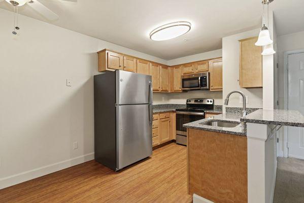 Gorgeous, updated kitchen with large refrigerator, space-saver microwave, and dining area.