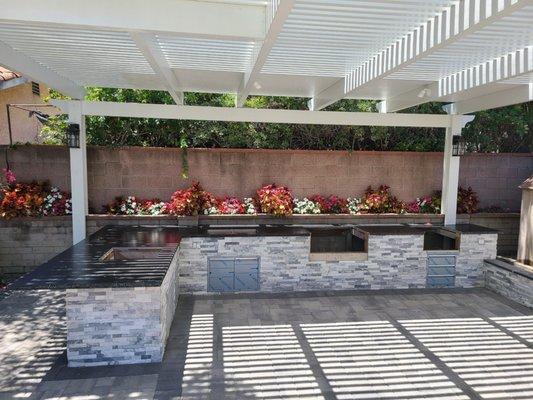 Counter, stacked stone,  patio cover and flooring in.