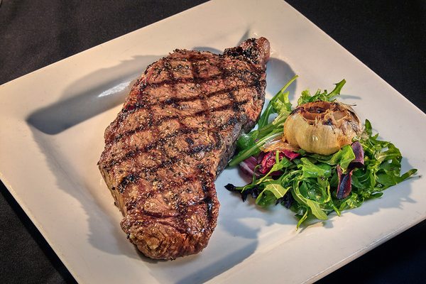 NEW YORK STRIP STEAK WITH ROASTED GARLIC 12 oz. Strip Steak with Choice of Sauce or Rub Roasted Garlic Balsamic or Béarnaise Sauces / Cajun