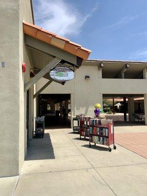 The entrance is adjacent to the hanging sign. The book carts are out when the store is open. Some items are free.