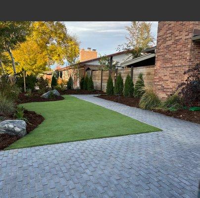 Project location: Arvada We demolished the existing landscape. Installed artificial turf, pavers, irrigation, planting, mulch night lighting